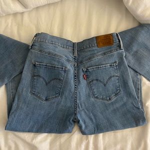 Levi’s 312 shaping slim medium wash jeans